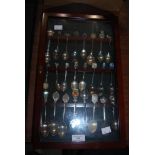 COLLECTION OF ASSORTED EP AND SILVER SOUVENIR SPOONS IN MAHOGANY WALL CABINET