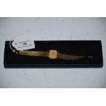 LADIES 9CT GOLD OMEGA WRIST WATCH WITH BATON NUMERALS AND 9CT GOLD STRAP, INSCRIBED TO THE REVERSE -