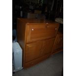 VINTAGE ERCOL SIDE CABINET WITH FALL FRONT DESK SECTION OVER TWO CUPBOARD DOORS AND SINGLE DRAWER