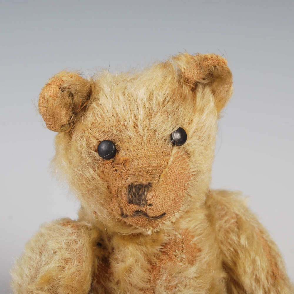 An early 20th century teddy bear, possibly Steiff, with golden mohair and brown/ black button boot - Image 2 of 10