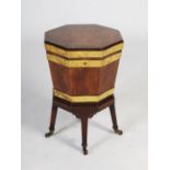 A George III mahogany and brass bound octagonal shaped wine cooler on integral stand, the hinged