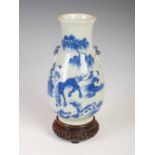 A Chinese porcelain celadon ground blue and white vase, Qing Dynasty, decorated with two horses in a