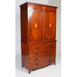 A George III mahogany, satinwood and ebony lined secretaire linen press, the moulded cornice above a