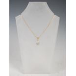 An 18 carat yellow gold pendant, set with a pear-shaped opal, on 18 carat gold trace-link chain,