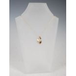 LAUREL JEWELLERY, A 9 carat yellow gold pendant, formed as a half matt/half polished open scroll