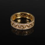 DOMINO JEWELLERY, An 18 carat yellow gold and diamond ring formed as two interlocking coronet bands,