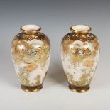 A pair of Japanese Satsuma pottery vases, Meiji Period, decorated with oval shaped panels of samurai