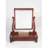 A William IV mahogany dressing table mirror, the rectangular mirror plate supported by scroll carved