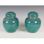 A pair of Monart jars and covers, shape Z, mottled blue/green glass with subtle whorl decoration,