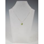 GRAHAM WILLIAMS, An 18 carat white gold, peridot and diamond pendant, set with a faceted cushion-