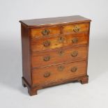 A George III mahogany chest of small proportions and shallow depth, the rectangular top with moulded