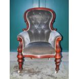 A Victorian mahogany parlour chair, the grey velvet upholstered button down back, arms and seat