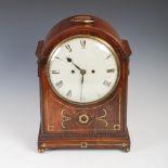 A Regency mahogany and brass inlaid bracket clock, the circular convex dial with Roman numerals,