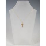 An 18 carat yellow gold cross pendant, on 18 carat gold trace-link chain, Stamped: WJP, 750 and
