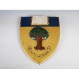 A carved painted and gilt wood crest for Feldon School, Milverton Hill, Leamington Spa, carved in