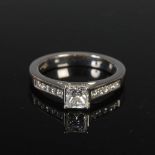 ANTWERP DIAMONDS, A platinum single stone diamond ring with diamond set shoulders, centred with a