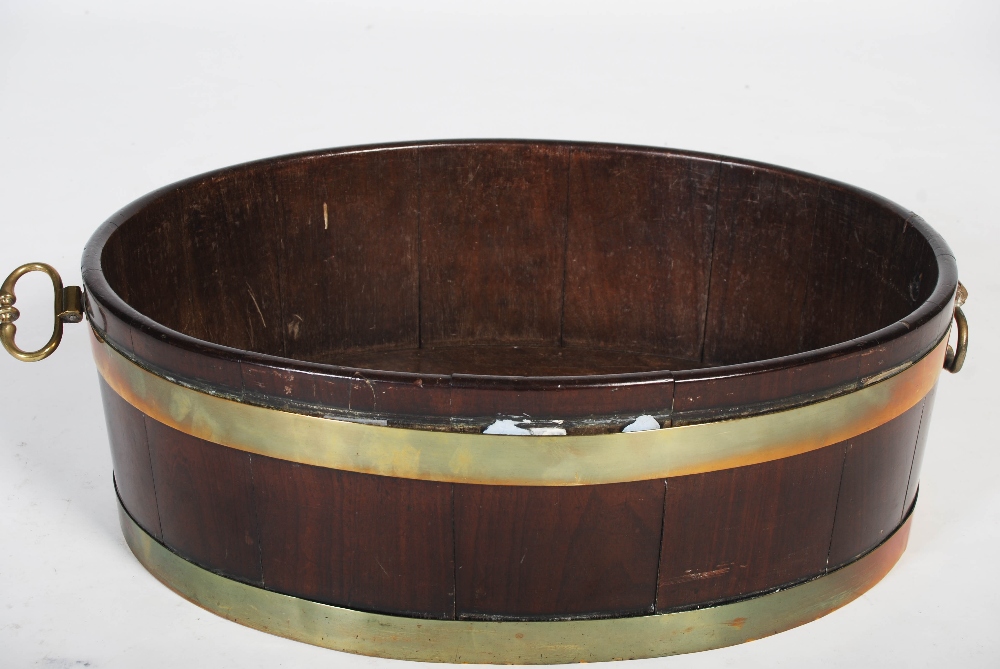 A George III mahogany and brass bound oval shaped cellarette, with brass drop handles to the - Image 4 of 6