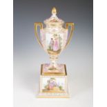 A late 19th/early 20th century Dresden porcelain twin handled urn and cover, decorated with courting