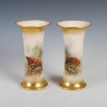 A pair of Royal Worcester porcelain vases decorated by John Stinton, dated 1922, decorated with