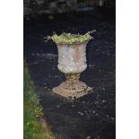 A composite stone urn, formed in two sections, 59cm high.