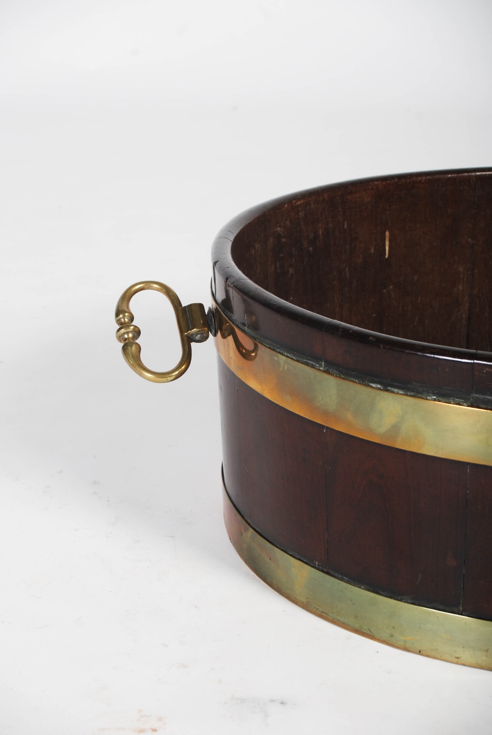 A George III mahogany and brass bound oval shaped cellarette, with brass drop handles to the - Image 2 of 6