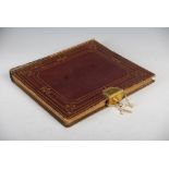 A mid 19th century red and gilt tooled leather album with Bramah, 124 Piccadilly, patent lock,