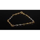 A 9 carat two-colour gold bracelet, with alternate yellow and white gold spiral links, Stamped: