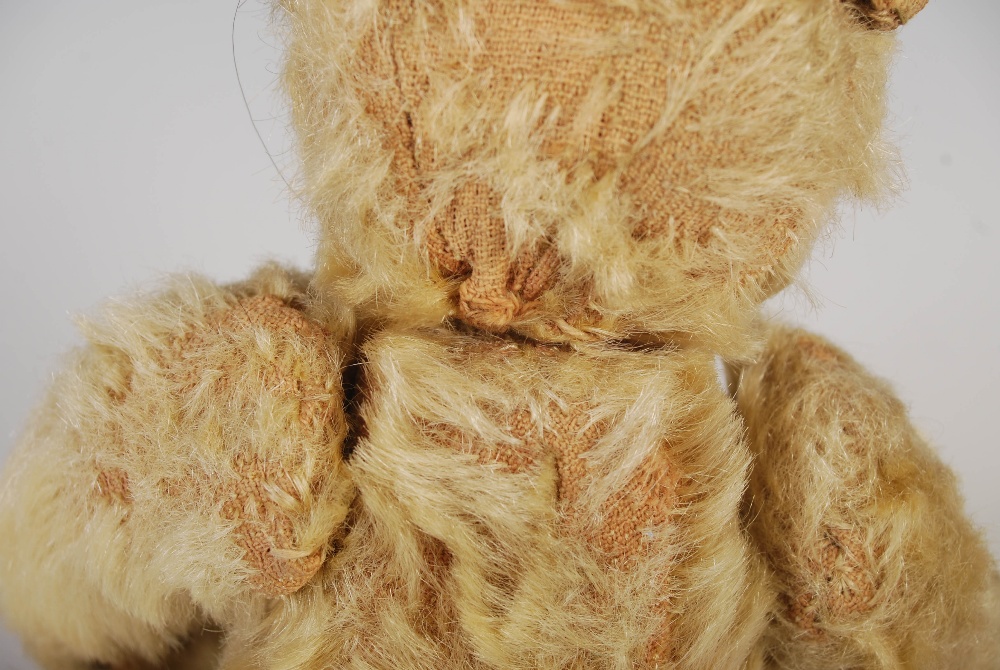 An early 20th century teddy bear, possibly Steiff, with golden mohair and brown/ black button boot - Image 5 of 10