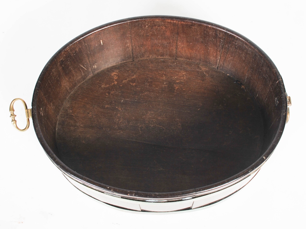 A George III mahogany and brass bound oval shaped cellarette, with brass drop handles to the - Image 5 of 6