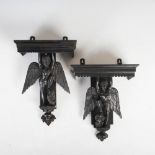 A pair of 19th century Anglo-Indian ebonised wall brackets, each carved with mythical winged figures