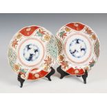 A pair of Japanese Imari plates, Meiji Period, decorated with central roundel of bamboo and pine,