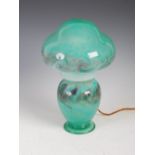 A Monart mushroom lamp and shade, mottled green and purple glass with bands of typical whorls and