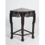 A Chinese dark wood corner table, Qing Dynasty, the shaped rectangular top with a red and white