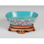 A Chinese porcelain famille rose dragon and phoenix oval shaped turquoise blue ground oval shaped