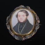 A Victorian yellow metal cased portrait miniature locket, the hinged oval portrait miniature painted
