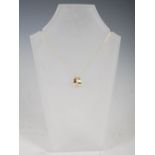 LAUREL JEWELLERY, A 9 carat two-colour gold and diamond pendant, set with eight diamonds on