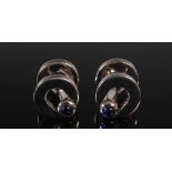 DEAKIN & FRANCIS, A pair of silver circular cufflinks, each set with two cabochon sapphires,