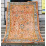 A late 19th century Ushak carpet, the abrashed salmon pink ground decorated with three rows of
