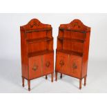 A pair of late 19th/early 20th century painted satinwood waterfall bookcases, the upright backs