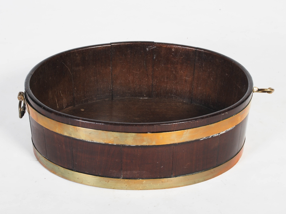 A George III mahogany and brass bound oval shaped cellarette, with brass drop handles to the - Image 6 of 6