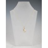 A 9 carat yellow gold and diamond pendant, set with twelve diamonds on pierced teardrop mount, on