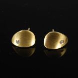 TEZER, A pair of 14 carat yellow gold oval earrings set with a small single diamond, Stamped: TEZER,
