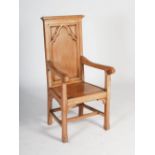 An early 20th century oak presentation altar armchair, the rectangular panelled back with Gothic