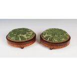 A pair of 19th century walnut and parquetry inlaid circular footstools, with green stuff over