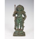 An Indian patinated bronze figure of a warrior, modelled standing on lotus throne and square