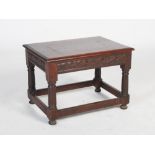 A late 19th century oak occasional table, the rectangular top above a foliate carved frieze,