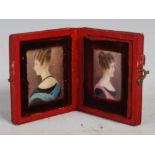 A 19th century leather cased double portrait miniature, opening to reveal two sisters, one with blue