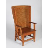 A late 19th/early 20th century Scottish pine Orkney chair, with woven back and scroll details to the