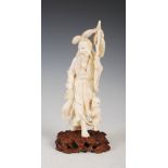 A Japanese ivory okimono of fisherman and boy, Meiji Period, signed, on carved wood stand, overall