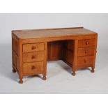 Mouseman - An oak knee hole desk, the rectangular adzed top above a central knee hole flanked by